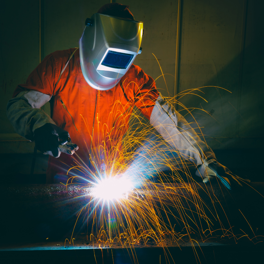 Industrial worker welding at factory